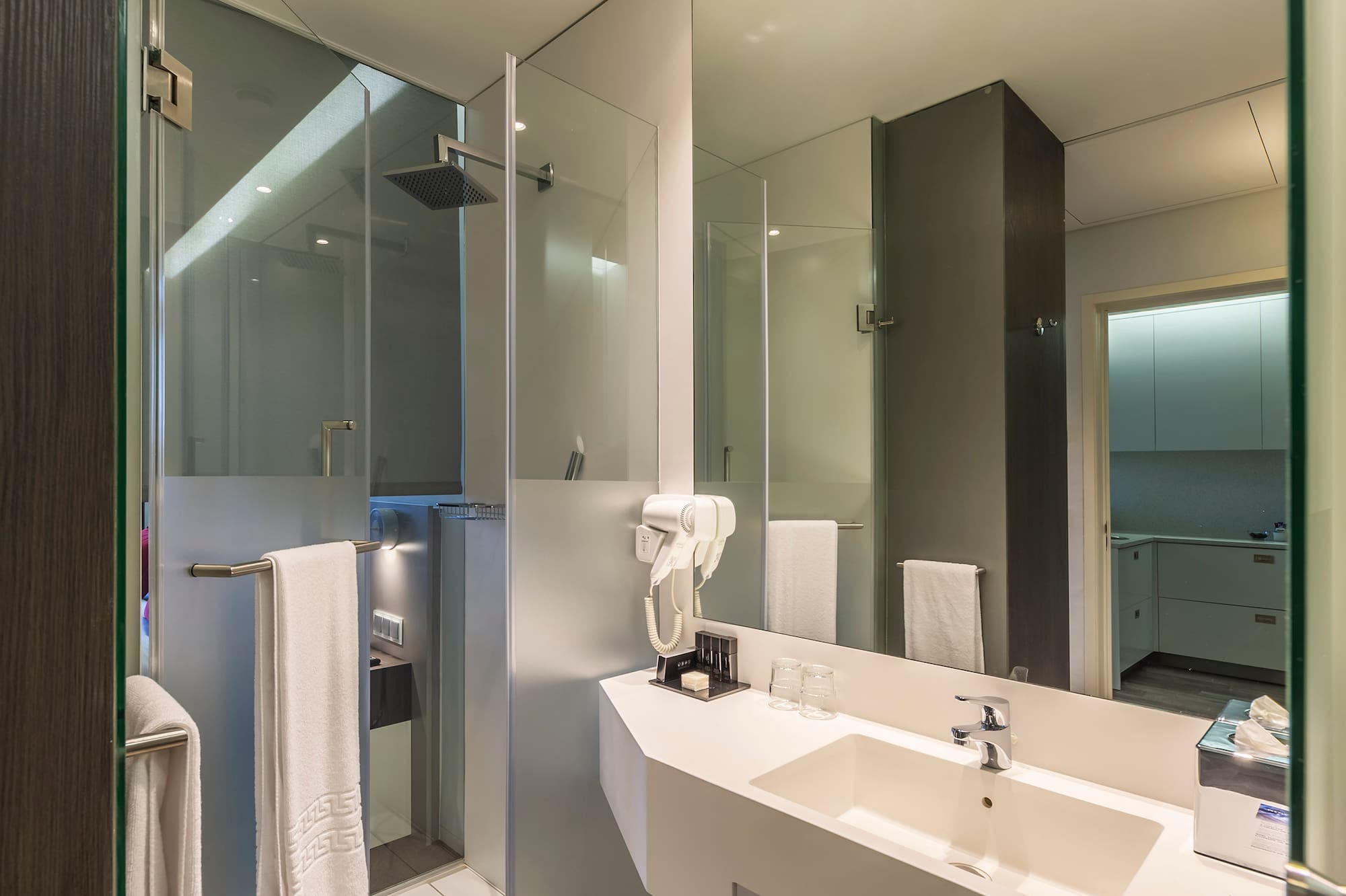 a bathroom with a shower and sink