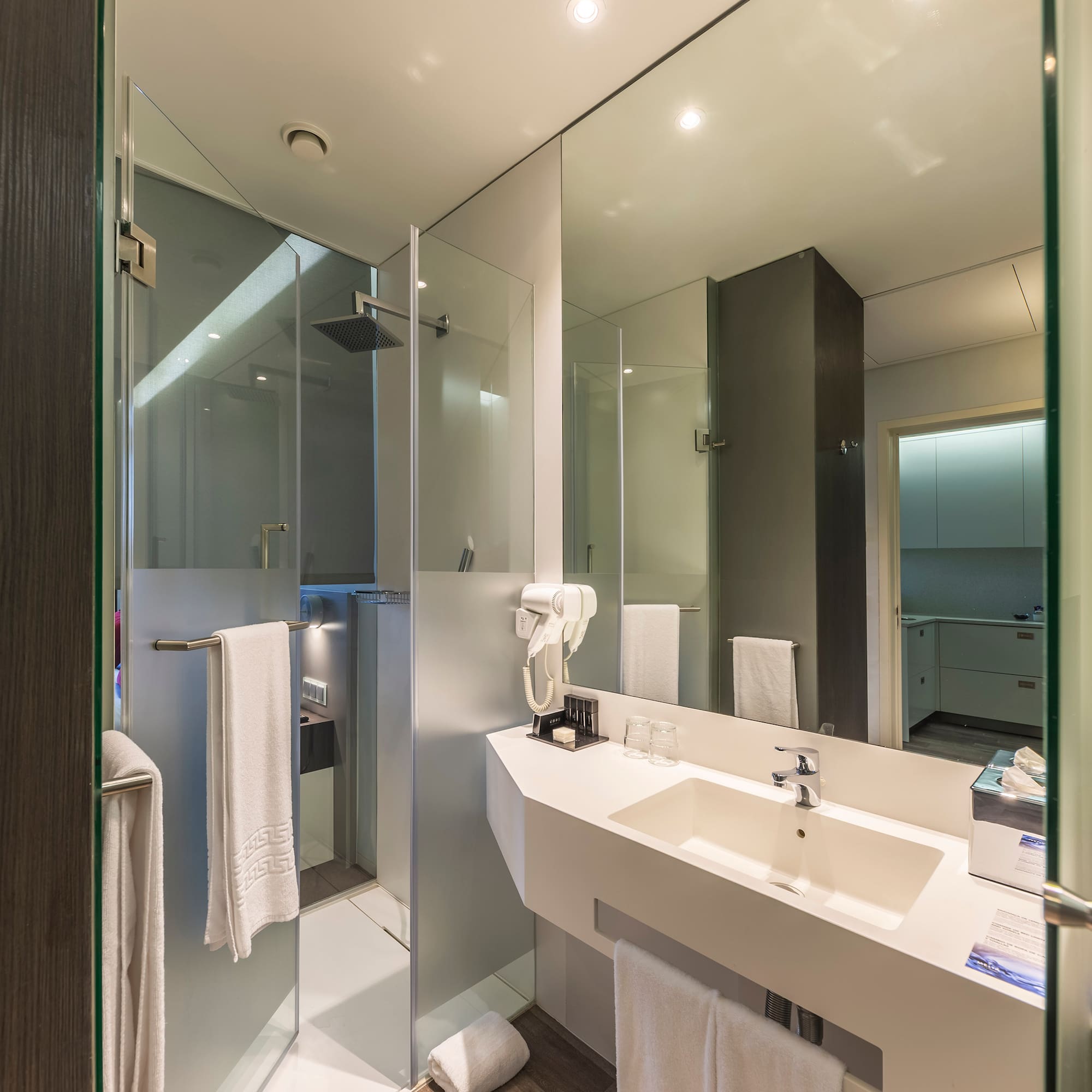 a bathroom with a shower and sink