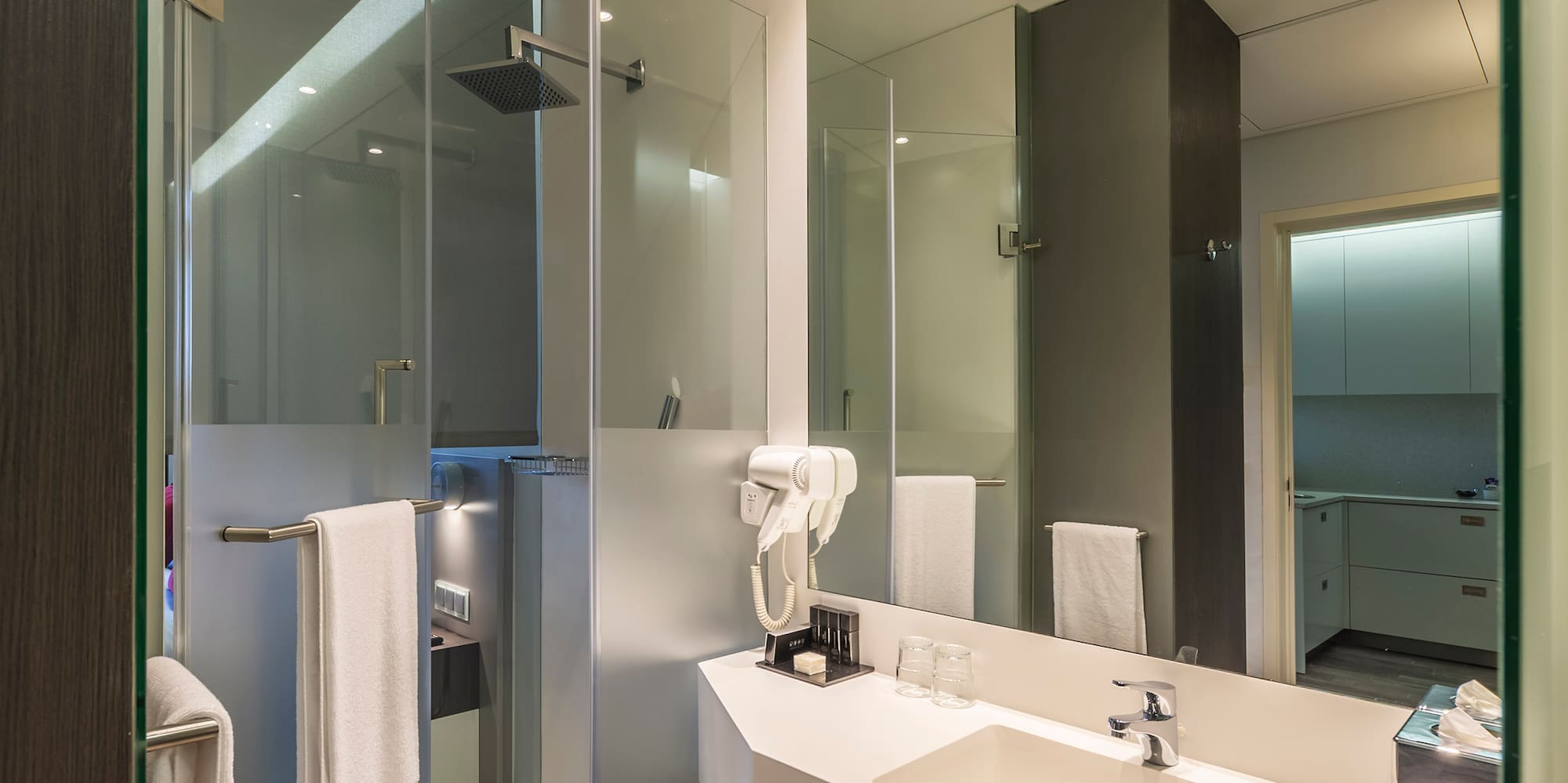 a bathroom with a shower and sink