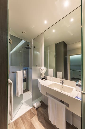 a bathroom with a shower and sink