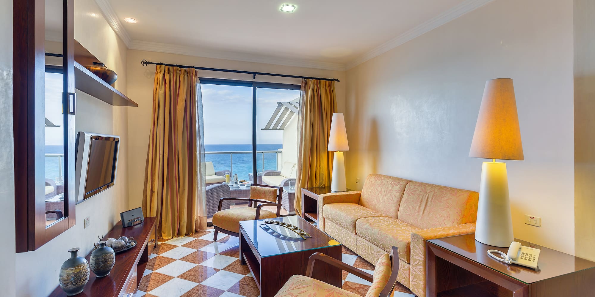 a room with a couch and a table and chairs