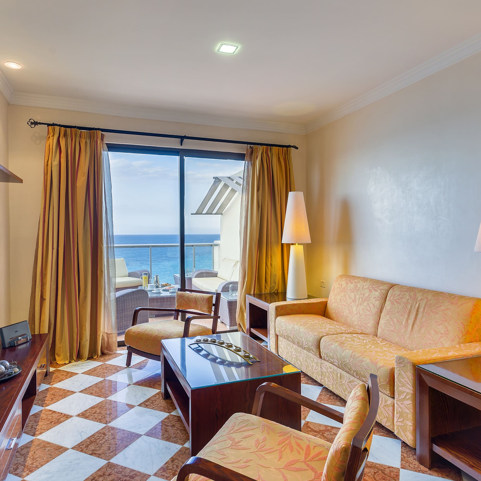 a room with a couch and a table and chairs