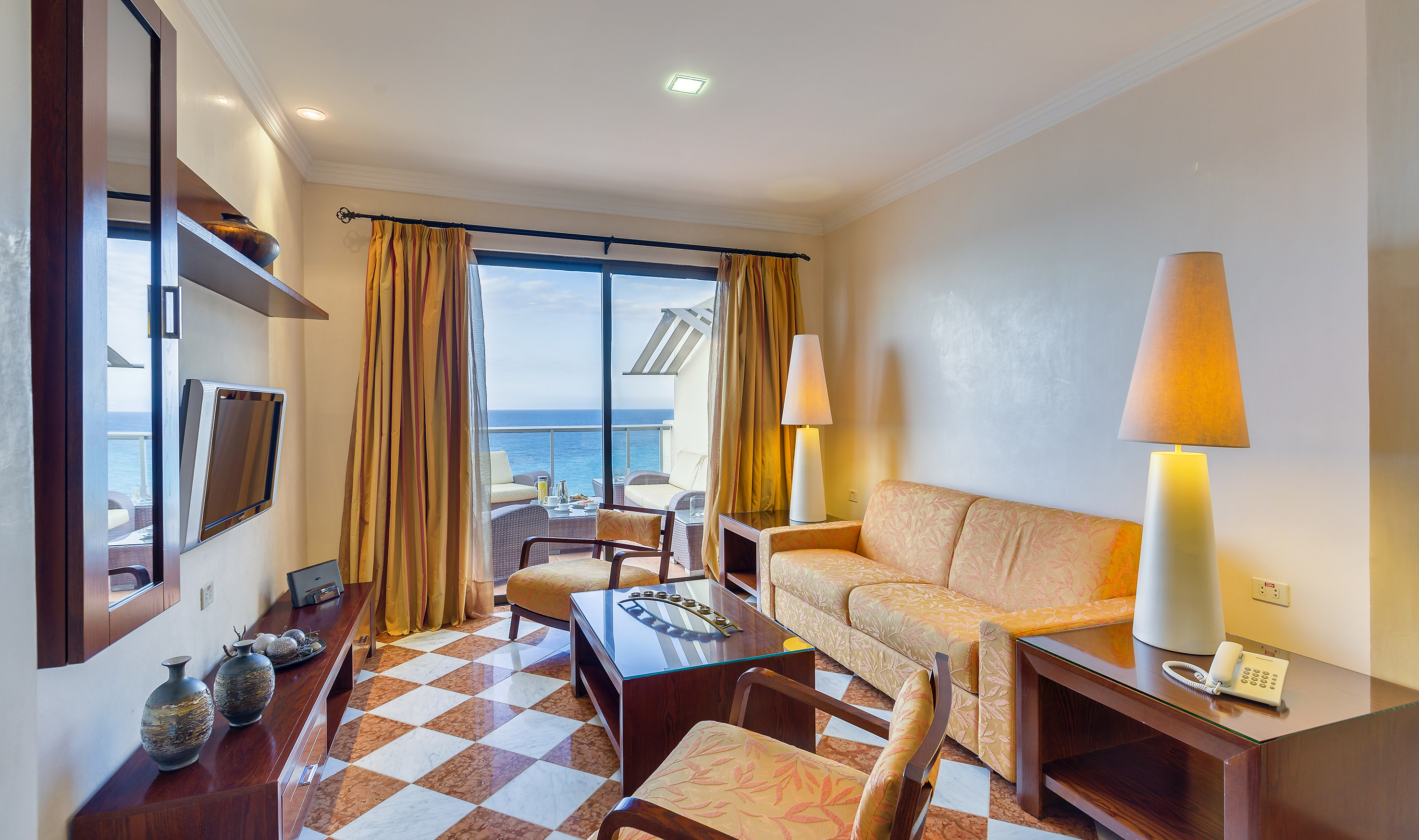 a room with a couch and a table and chairs