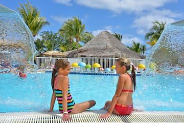 two girls sitting in a pool