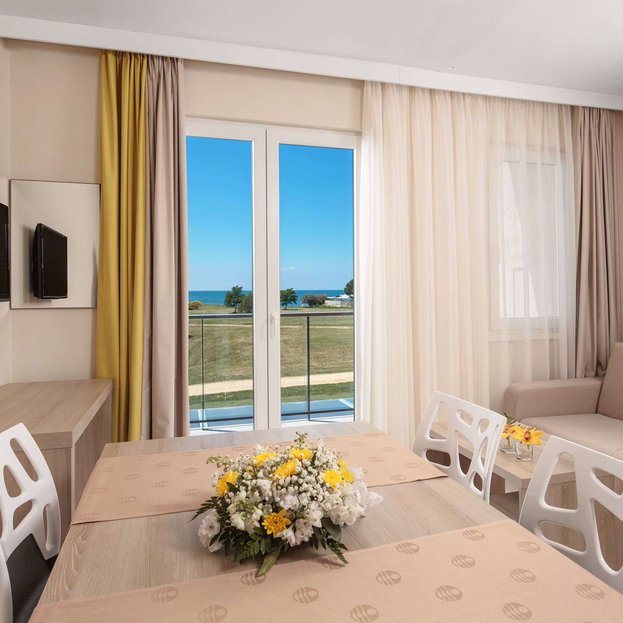 a room with a table and chairs and a television