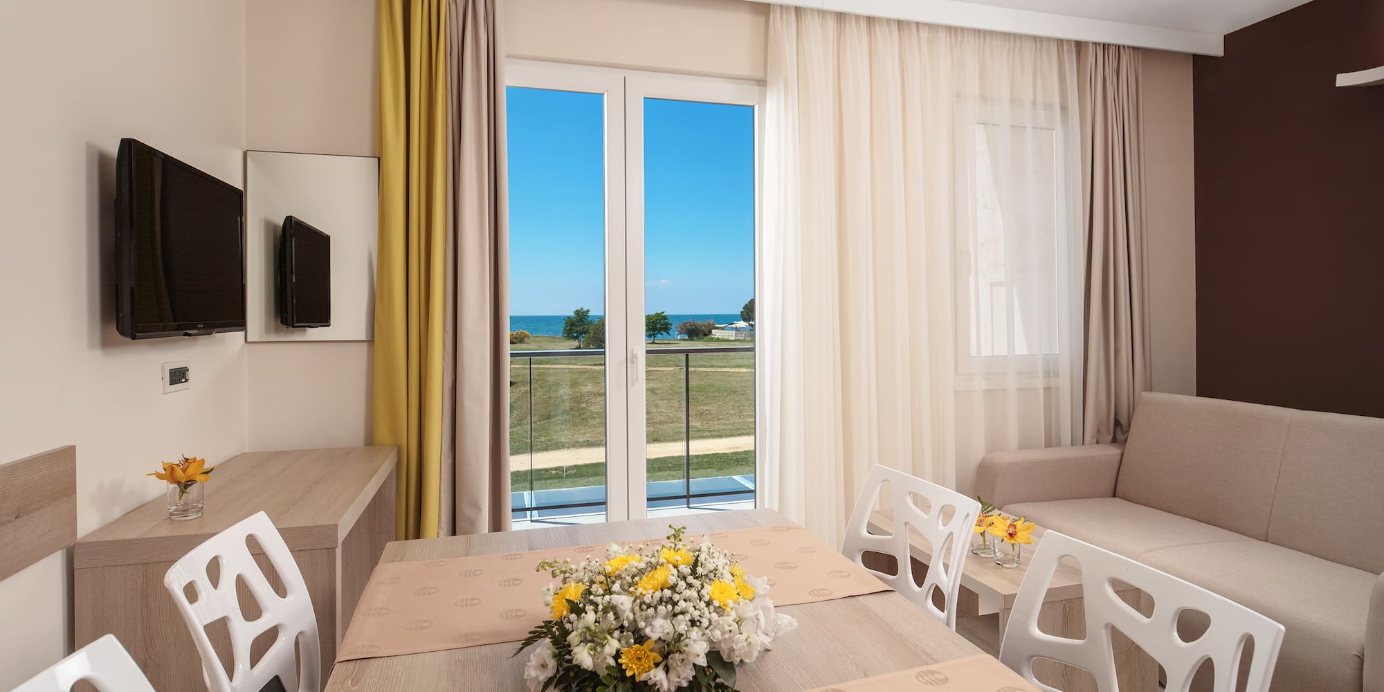 a room with a table and chairs and a television