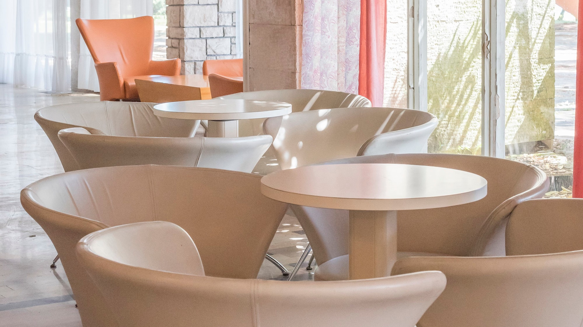 a group of tables and chairs in a room