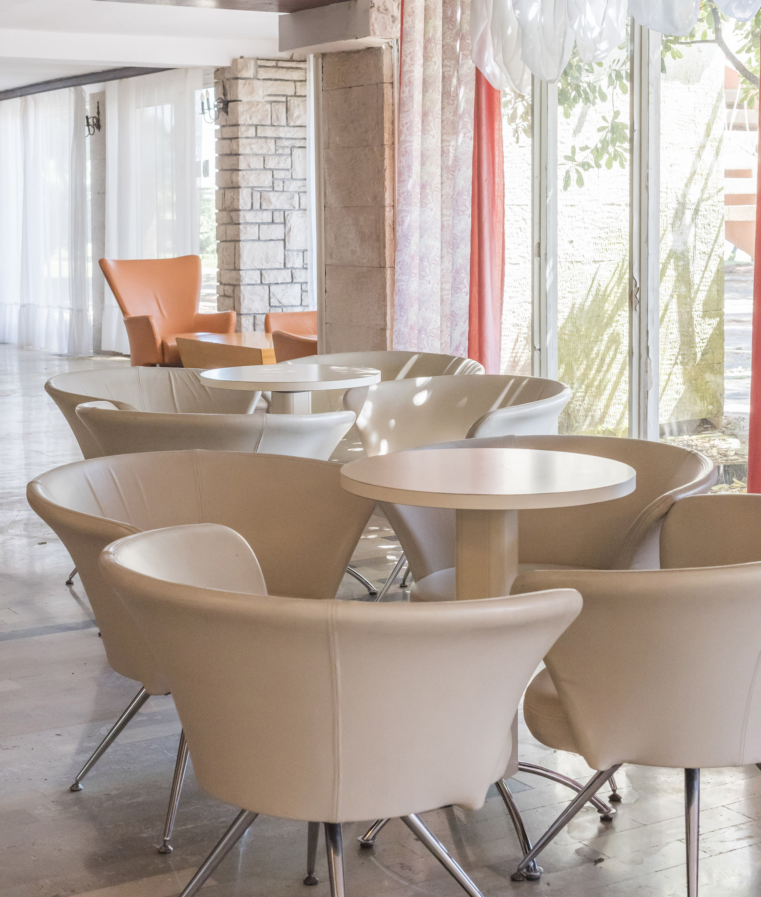 a group of tables and chairs in a room