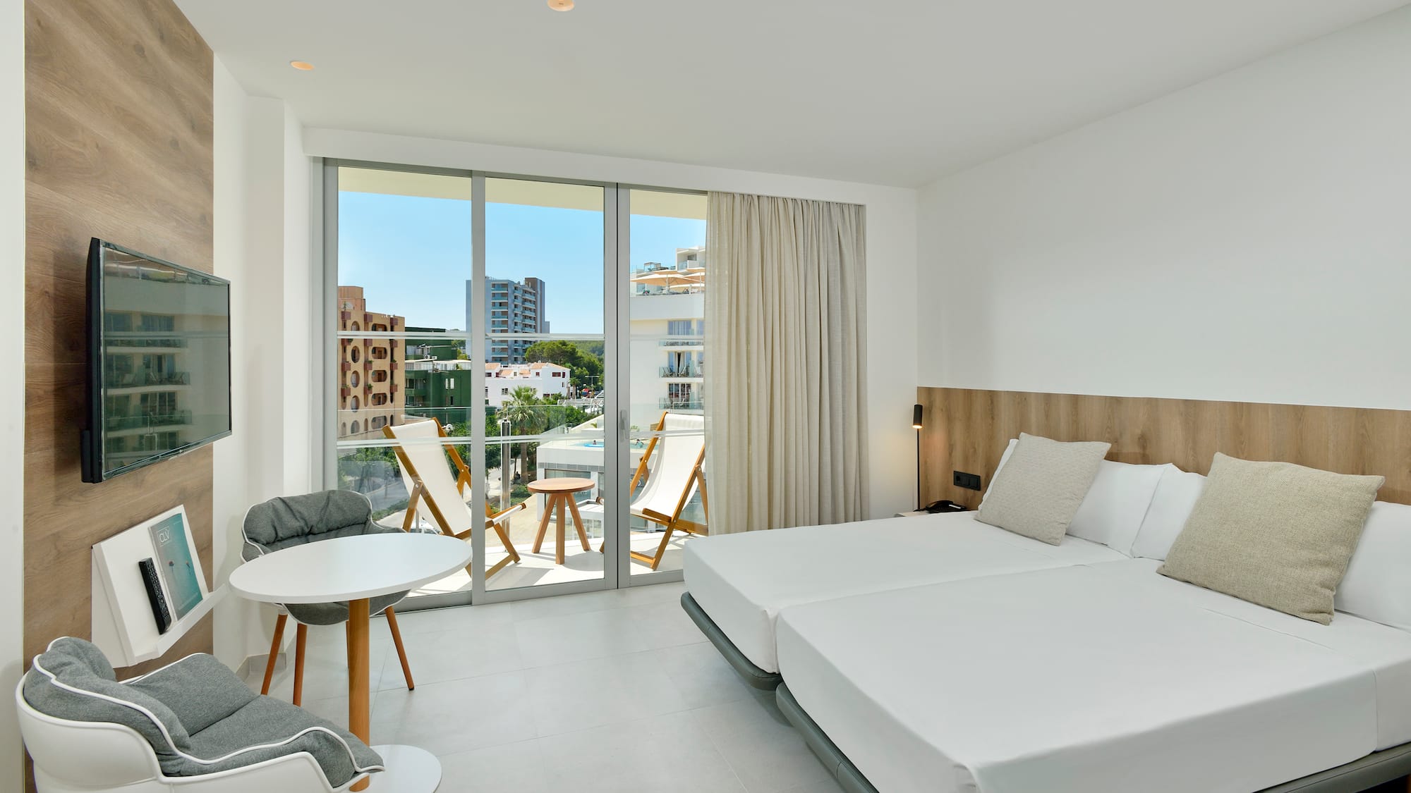 a room with a bed and chairs and a table