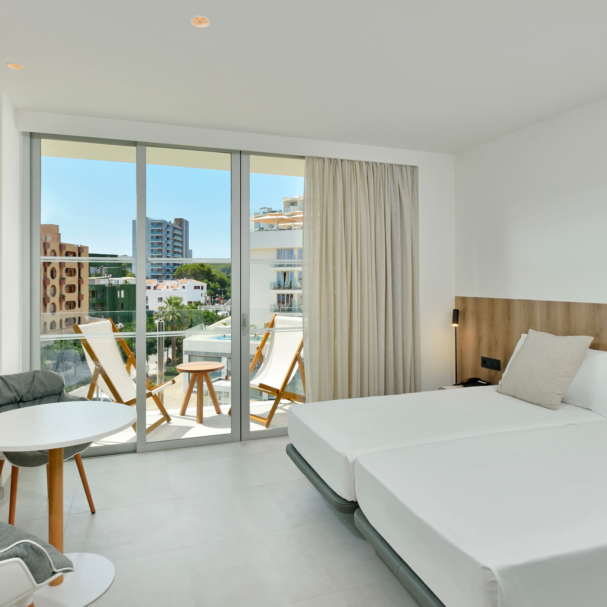 a room with a bed and chairs and a table