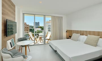 a room with a bed and chairs and a table