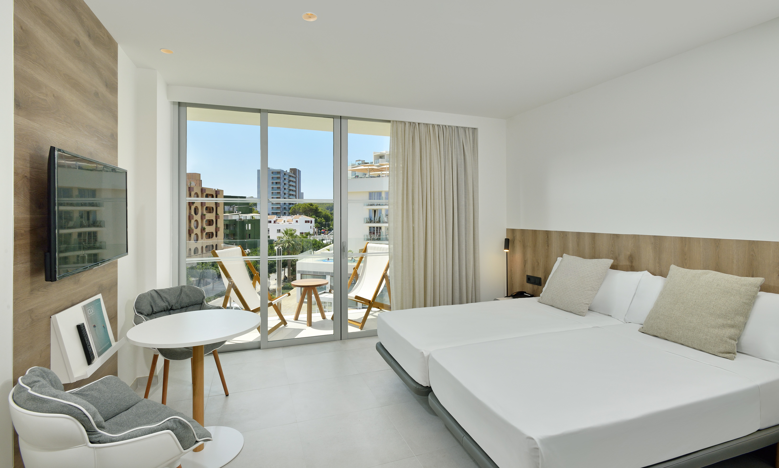 a room with a bed and chairs and a table