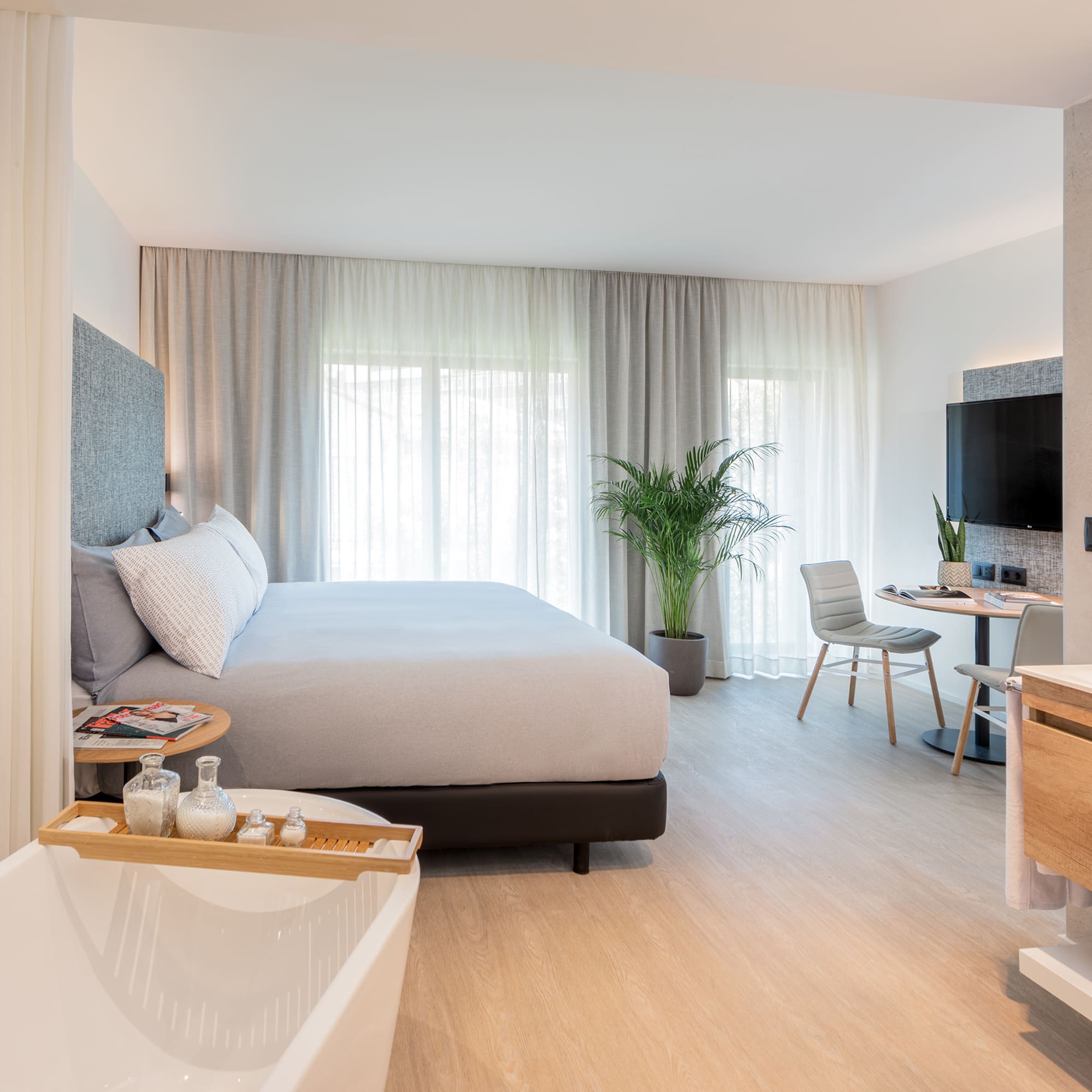 a bedroom with a bed and a bathtub