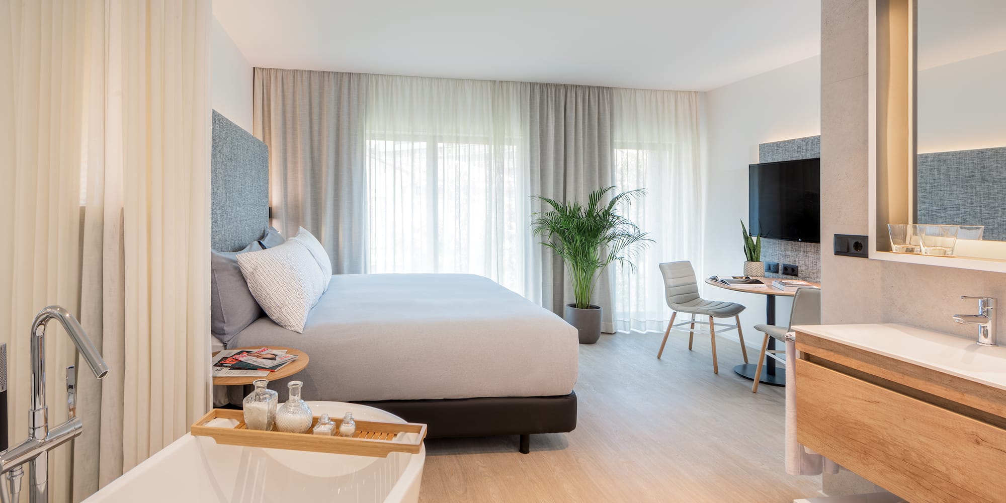 a bedroom with a bed and a bathtub