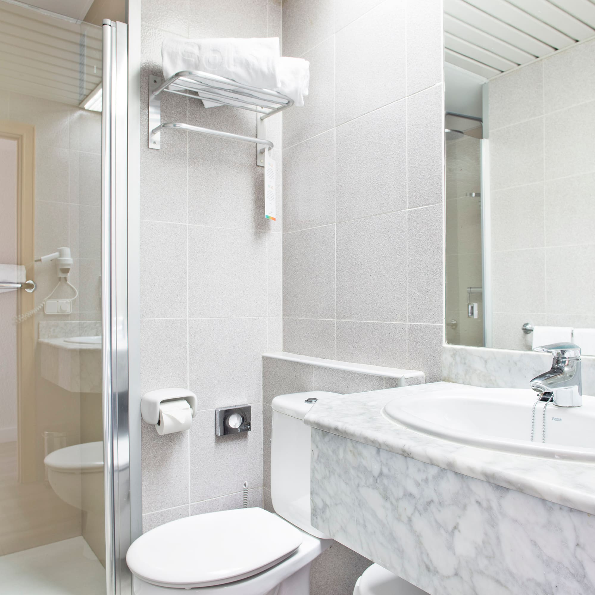 a bathroom with a marble countertop and sink