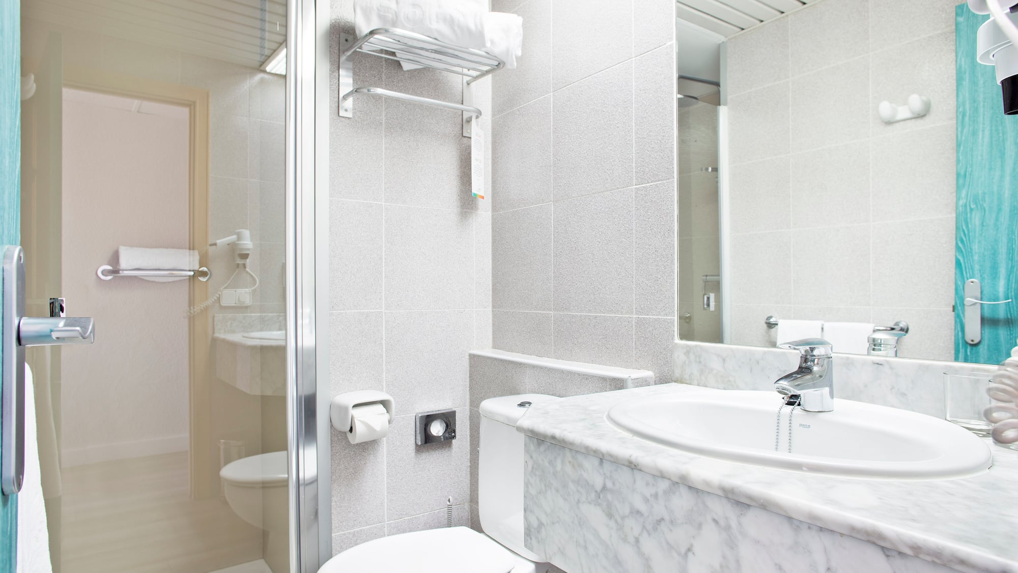a bathroom with a marble countertop and sink