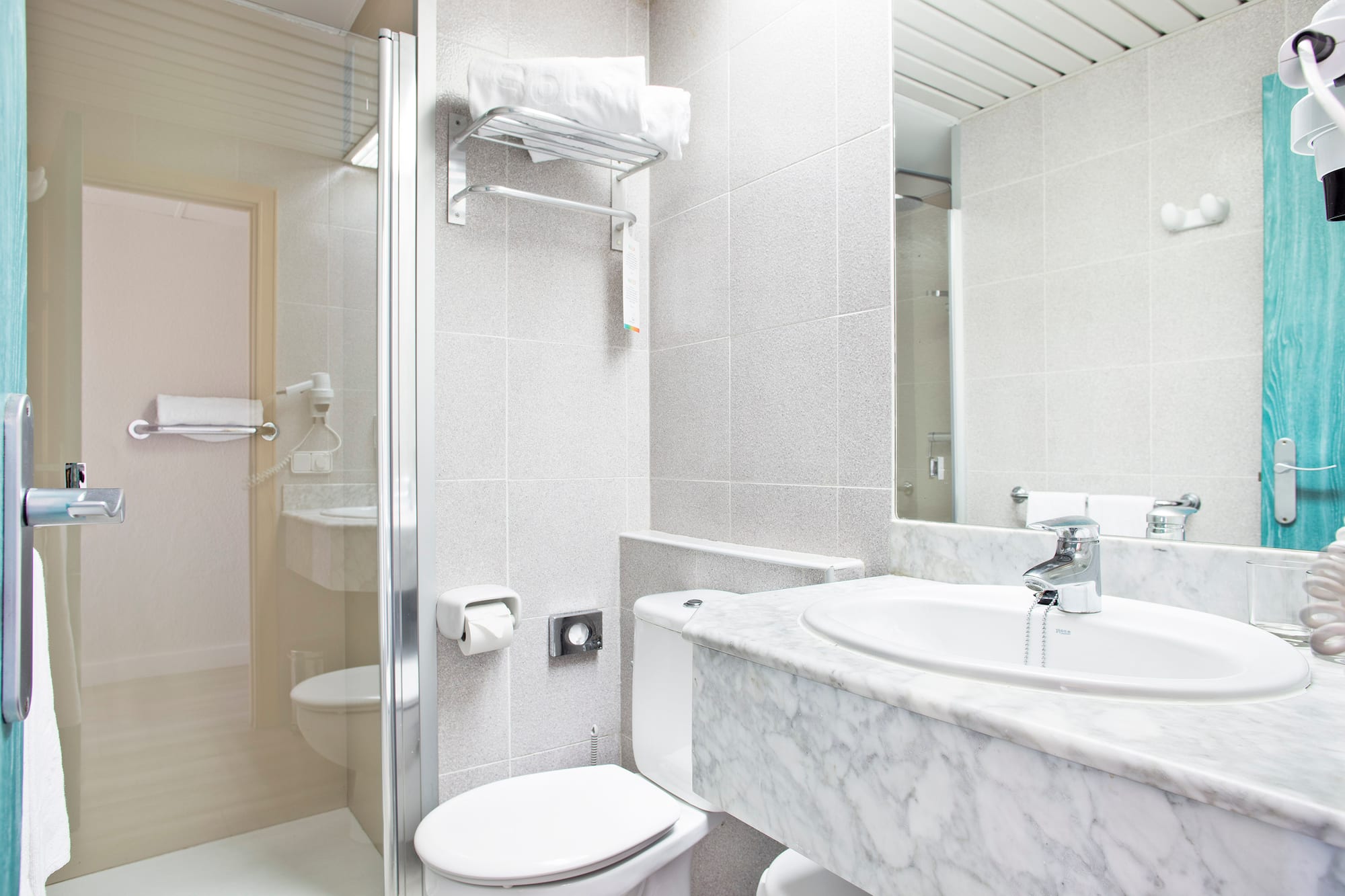 a bathroom with a marble countertop and sink
