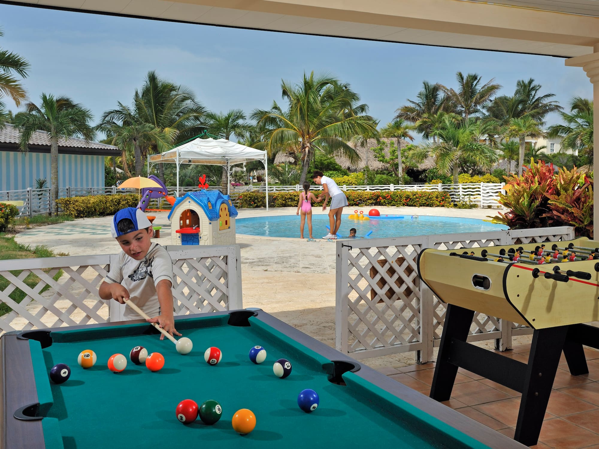 a boy playing pool with a pool table