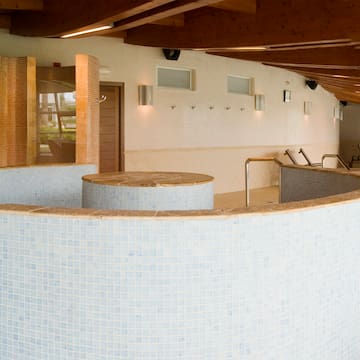 a room with a round pool