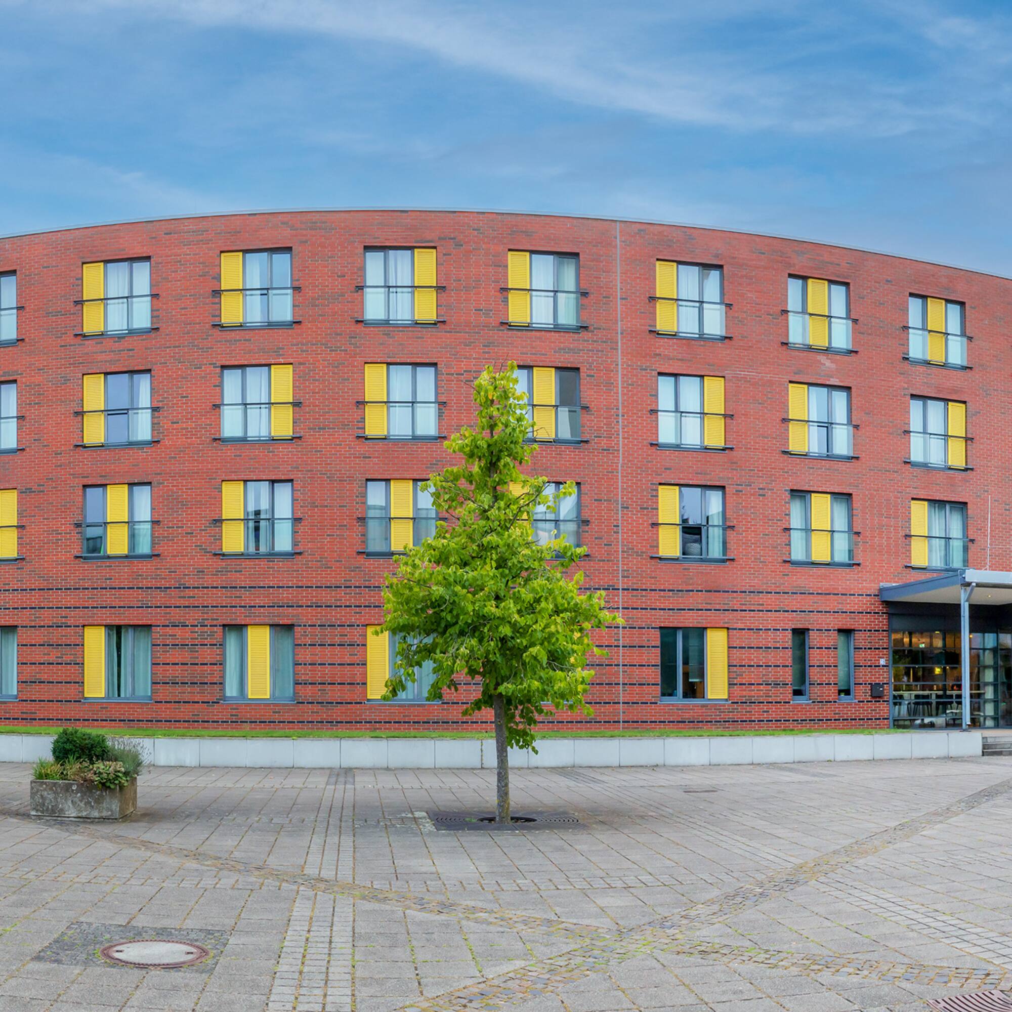 a building with a tree in front of it