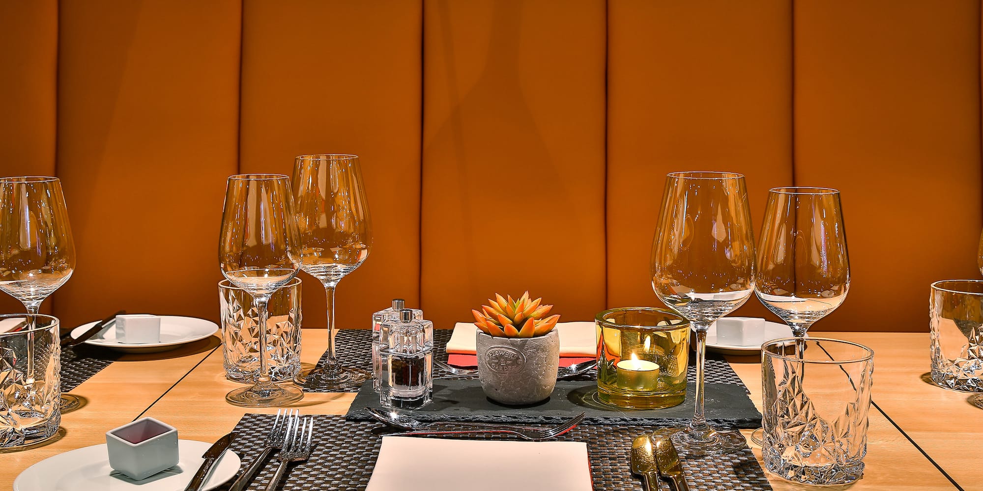 a table with a set of glasses and plates