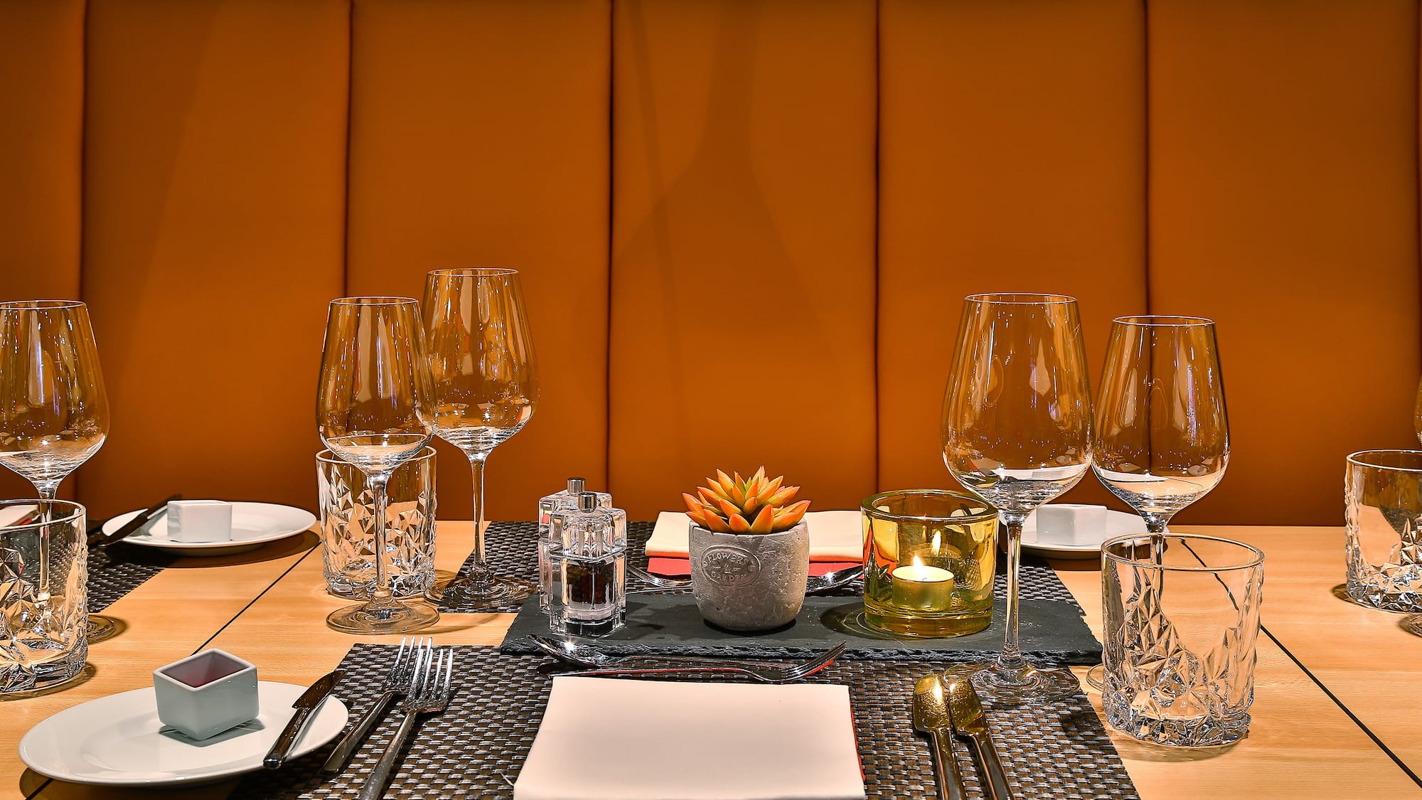 a table with a set of glasses and plates