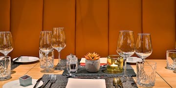 a table with a set of glasses and plates