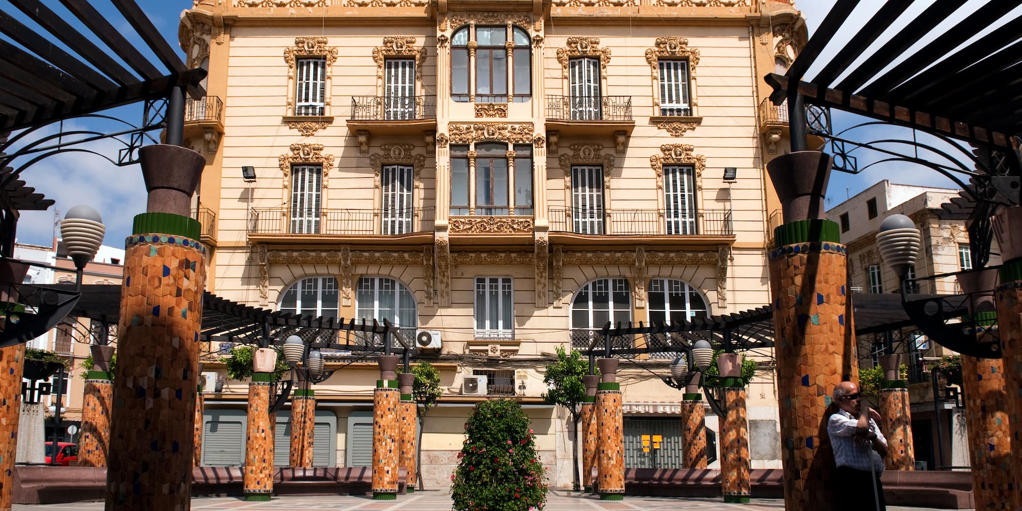 a building with columns and a tree in the middle