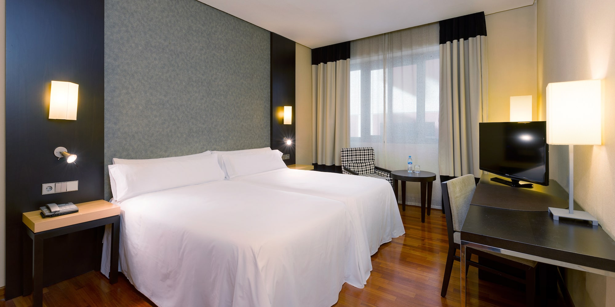 a room with two beds and a table