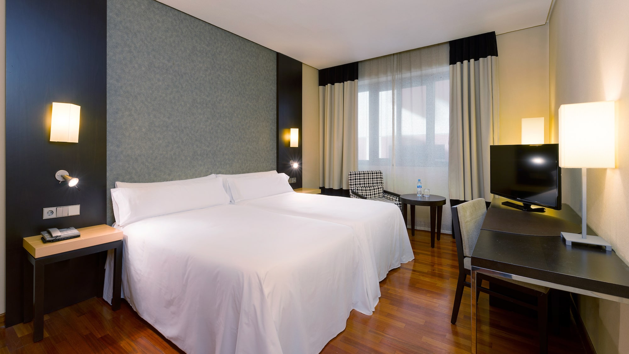 a room with two beds and a table