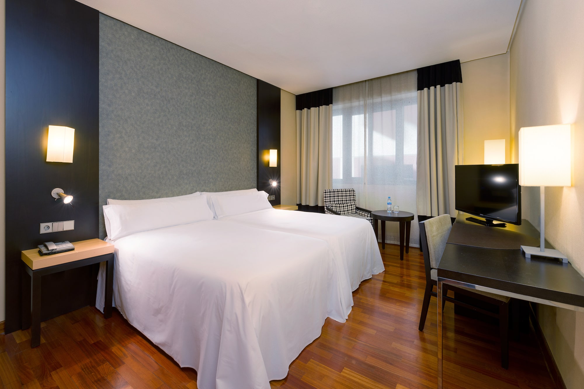 a room with two beds and a table