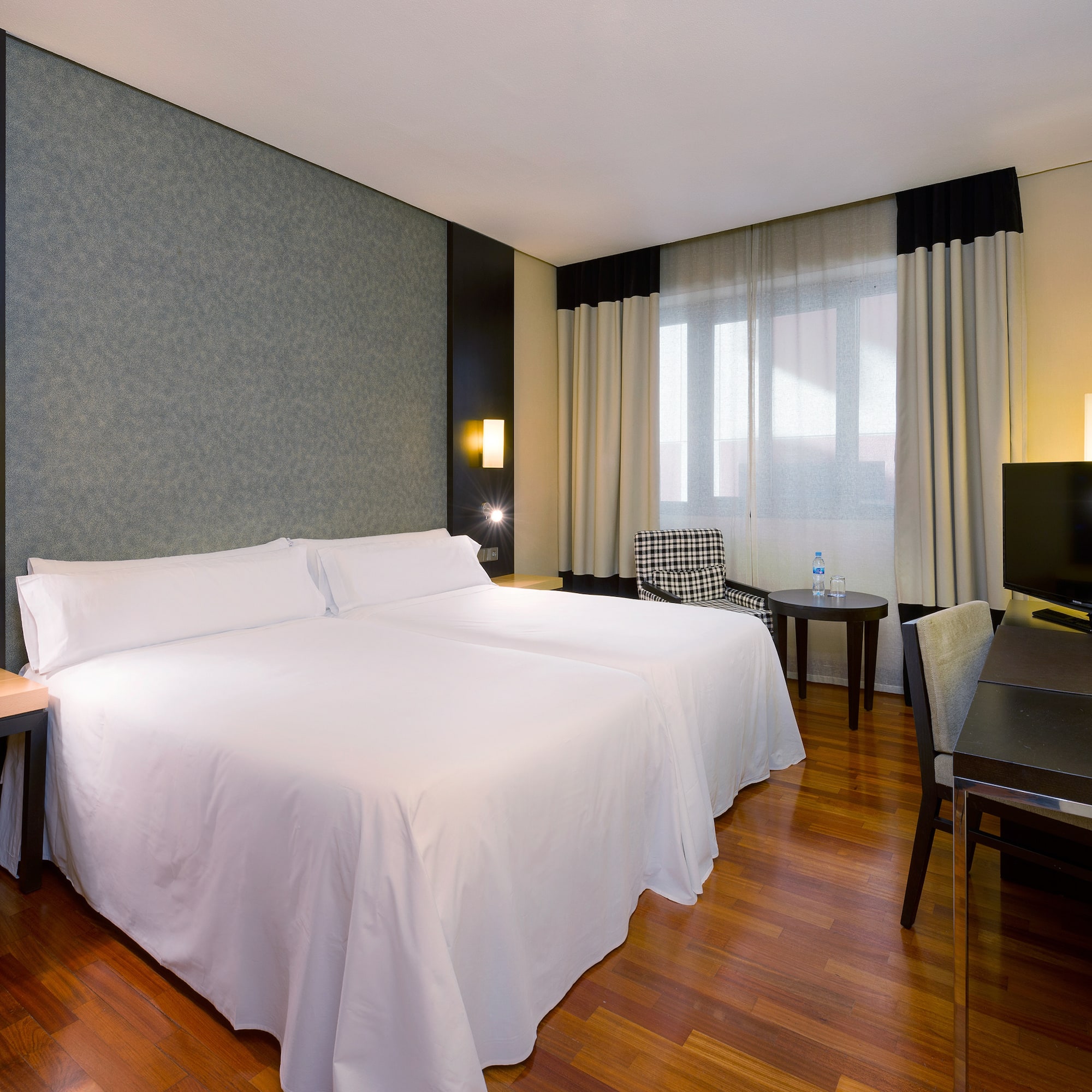 a room with two beds and a table