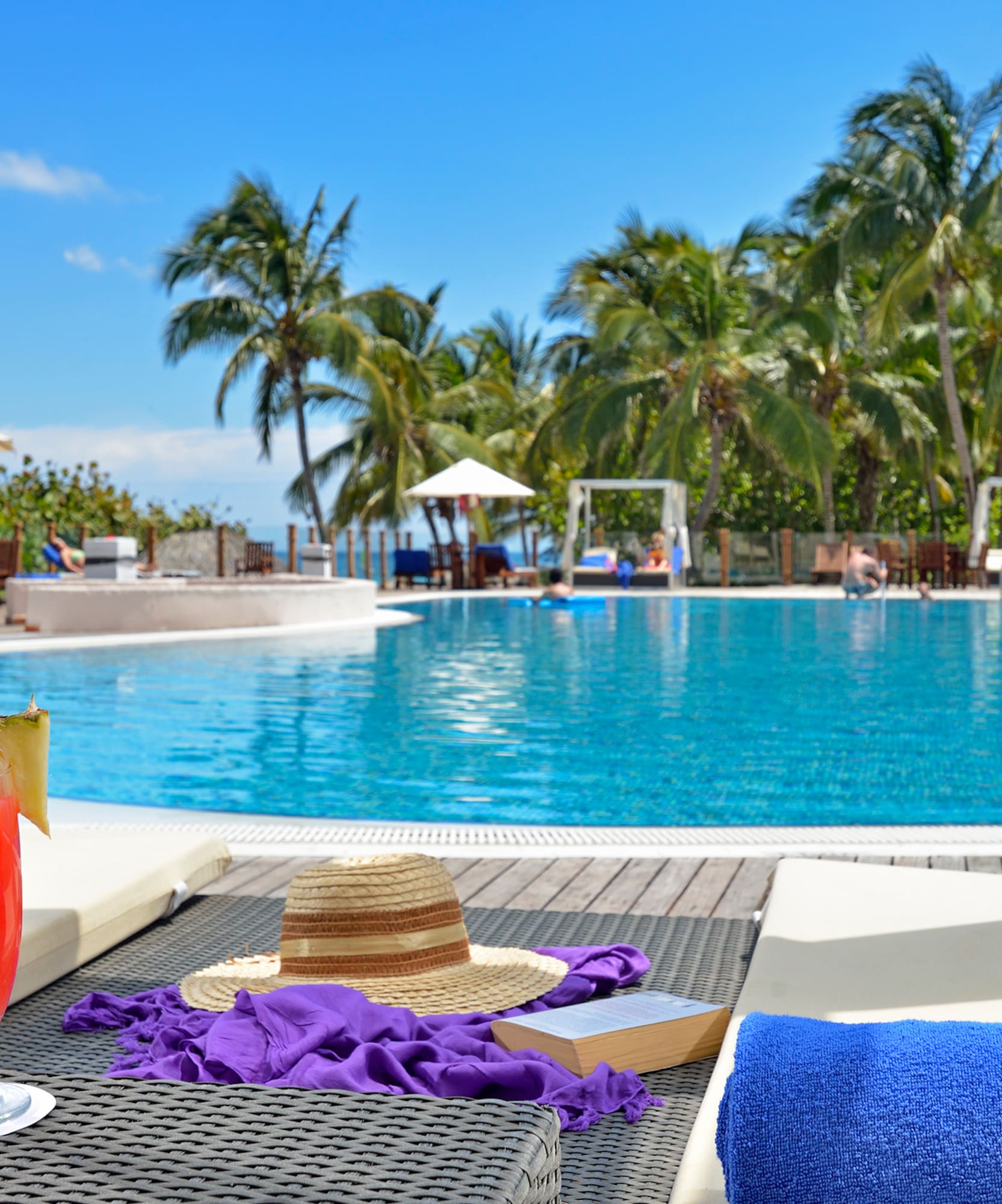 a pool with a drink and a hat
