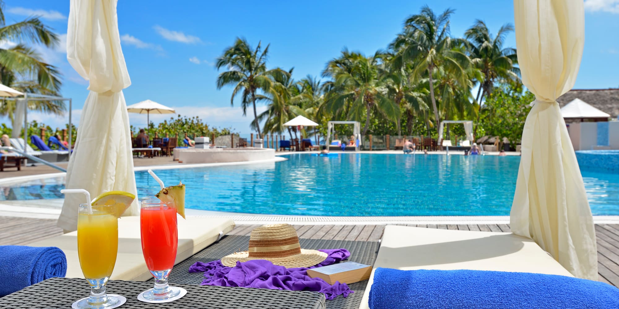 a pool with a drink and a hat