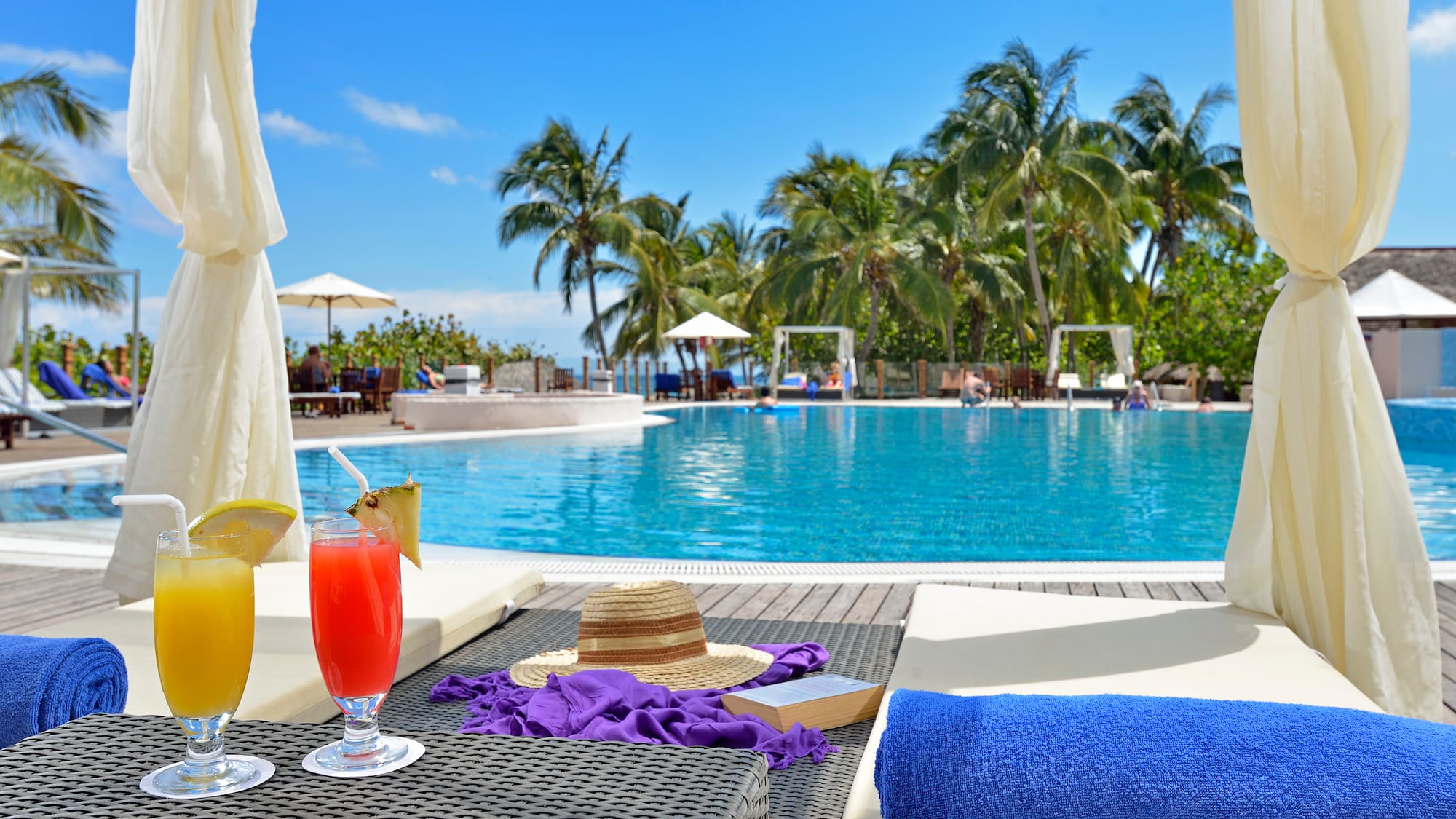 a pool with a drink and a hat