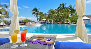 a pool with a drink and a hat