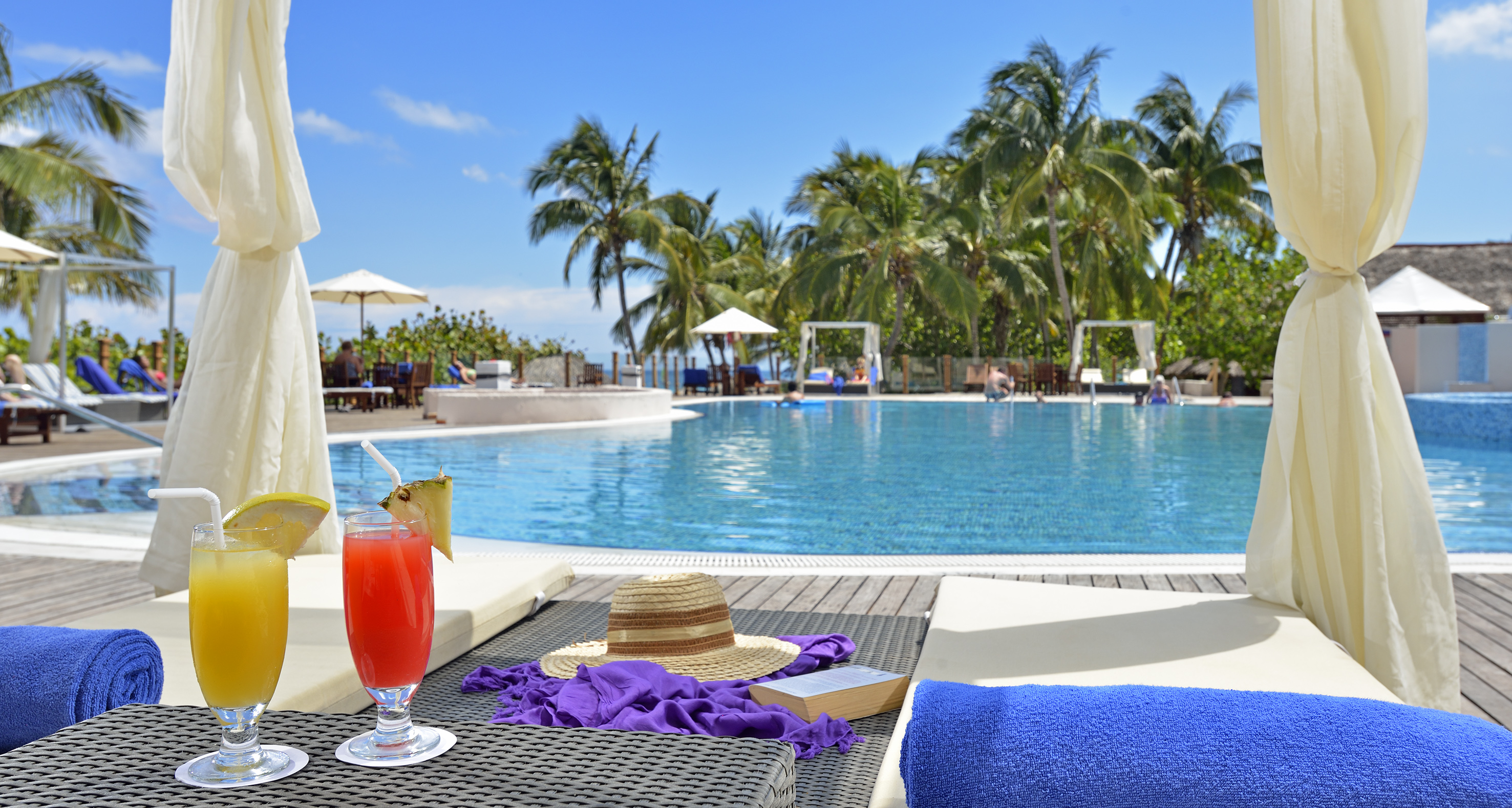 a pool with a drink and a hat