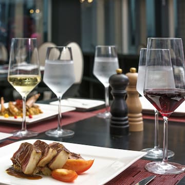 a table with plates of food and wine glasses