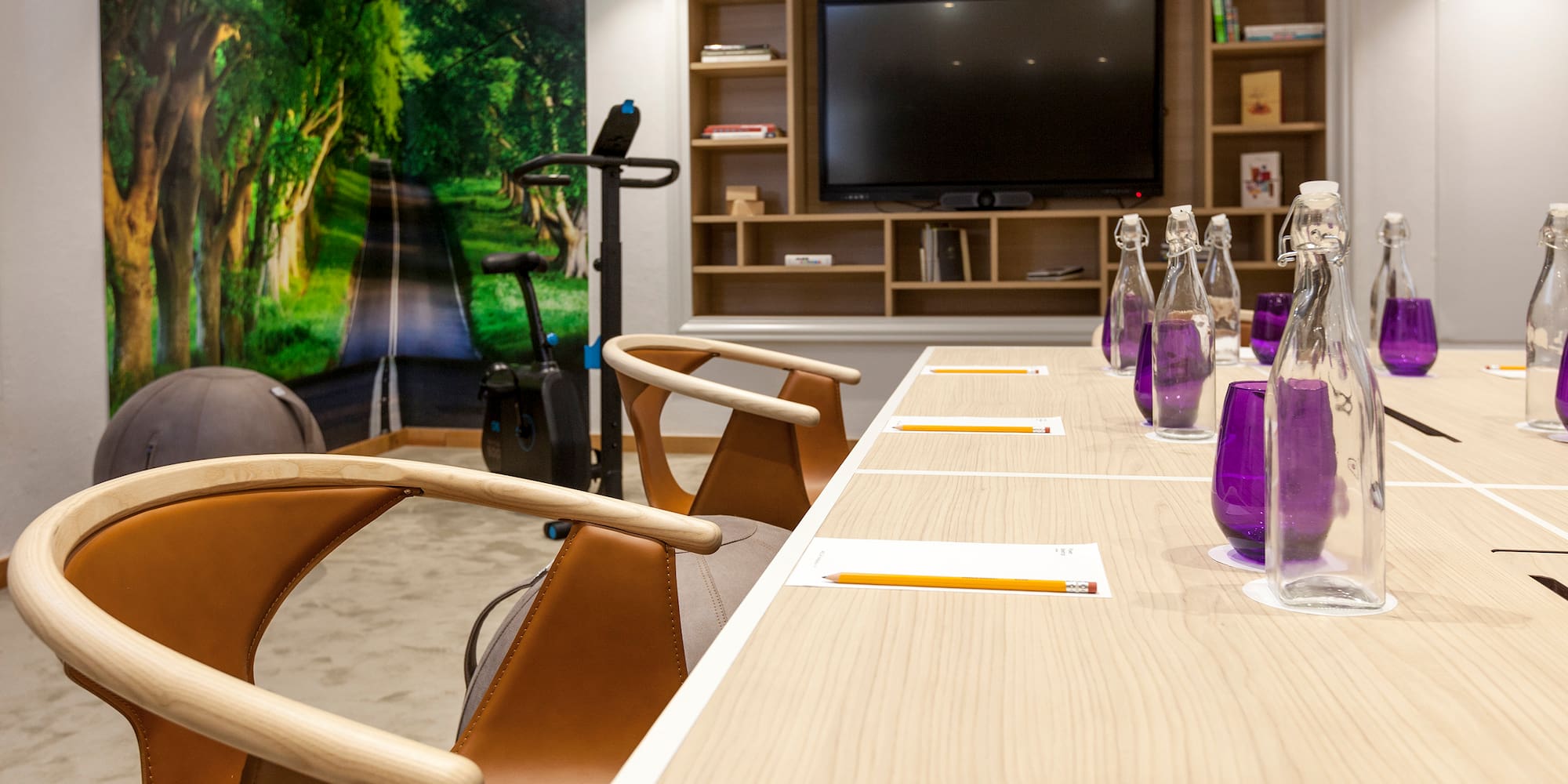 a table with chairs and a television in the background