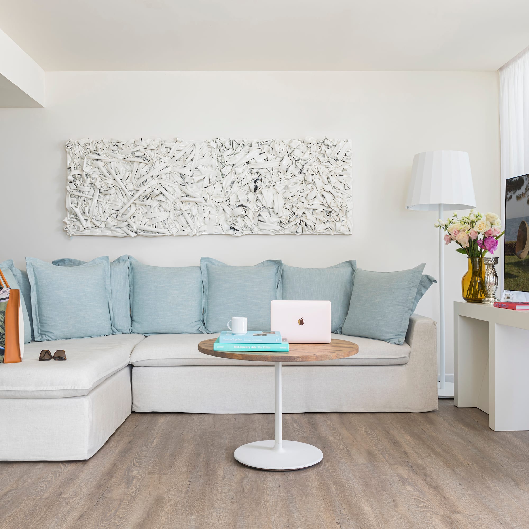 a living room with a couch and a laptop