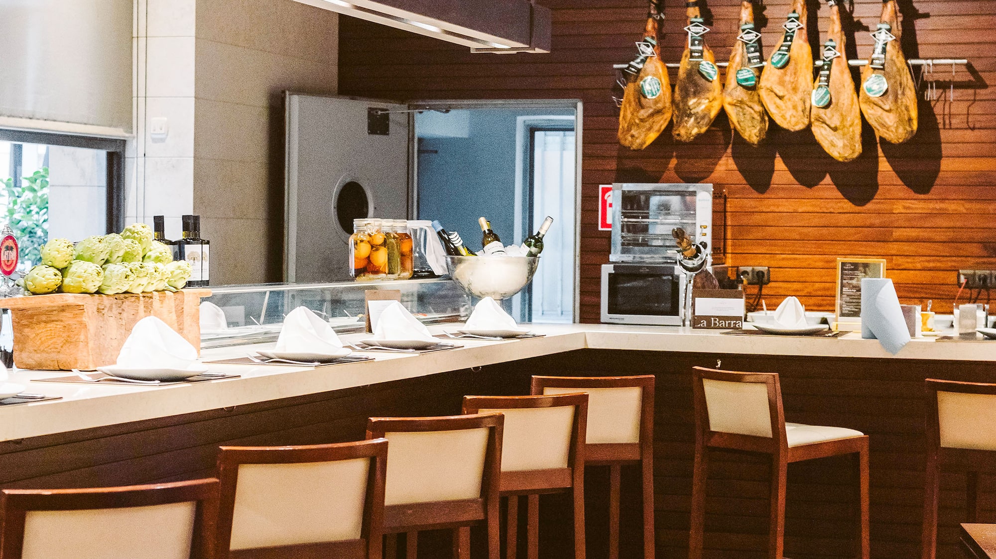 a kitchen with a counter and chairs