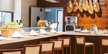 a kitchen with a counter and chairs