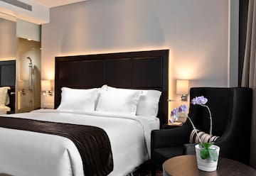 a bed with a black headboard and a chair