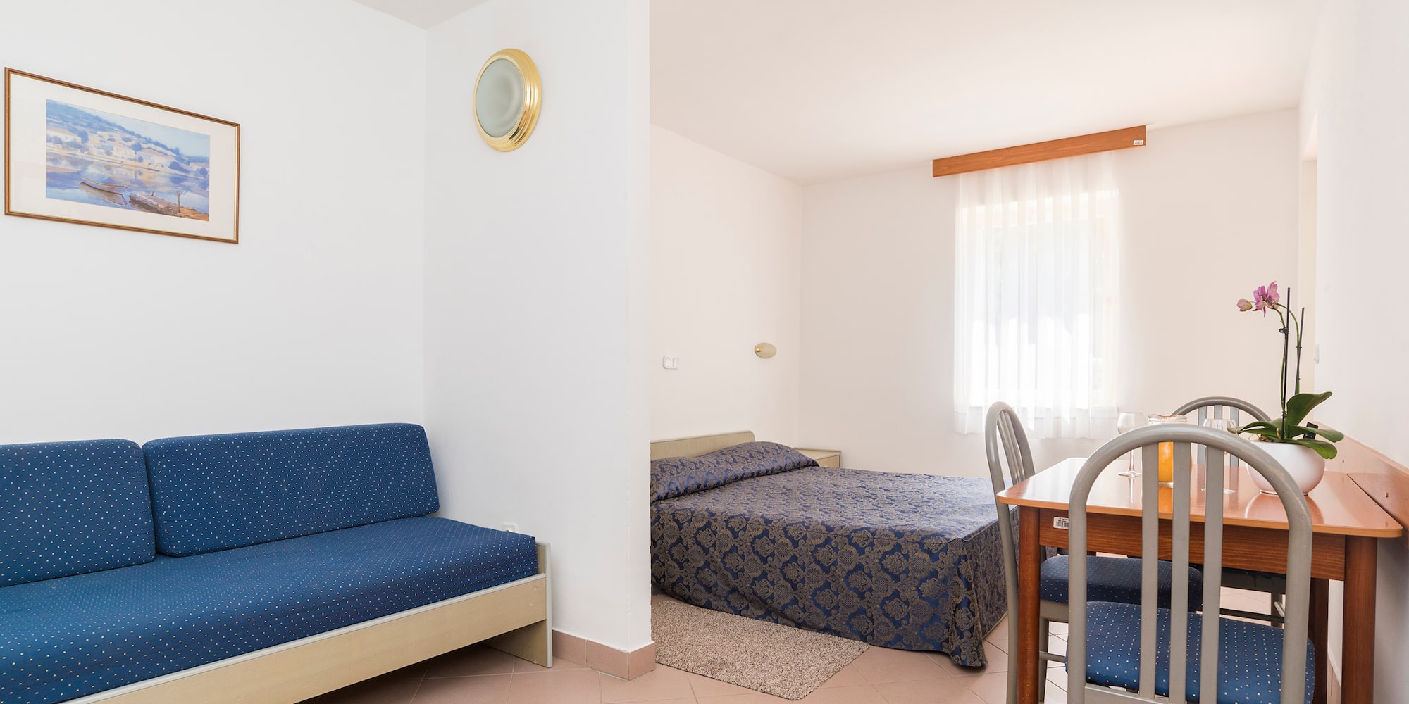 a room with a table and two beds