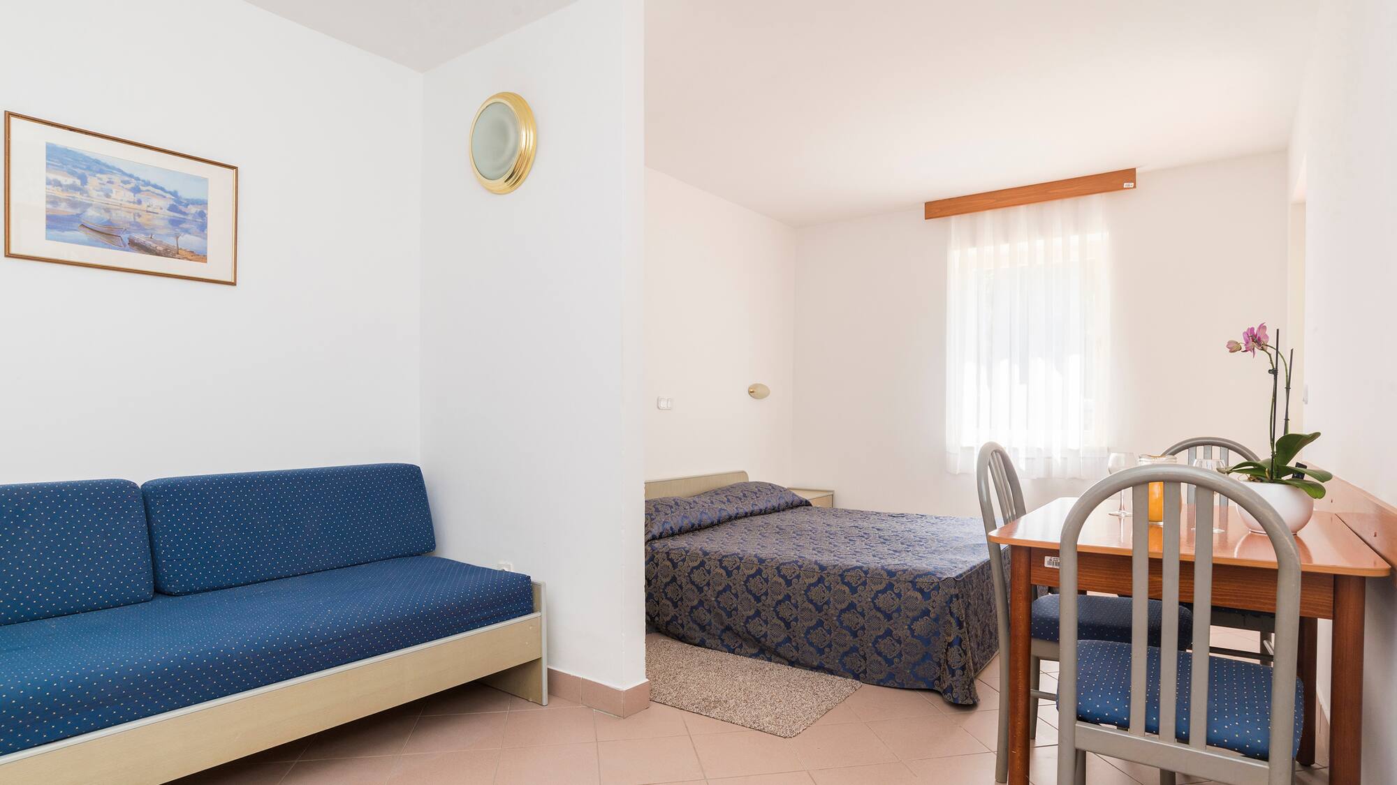 a room with a table and two beds