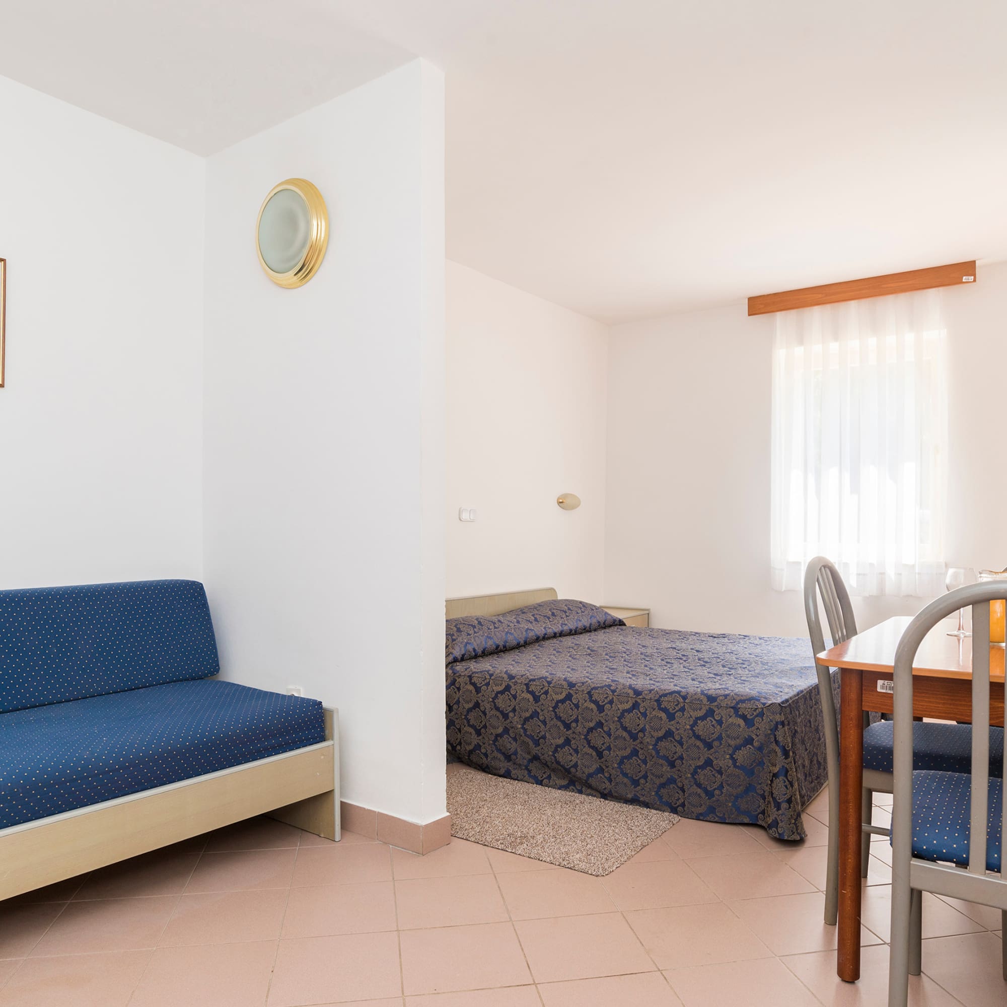 a room with a table and two beds