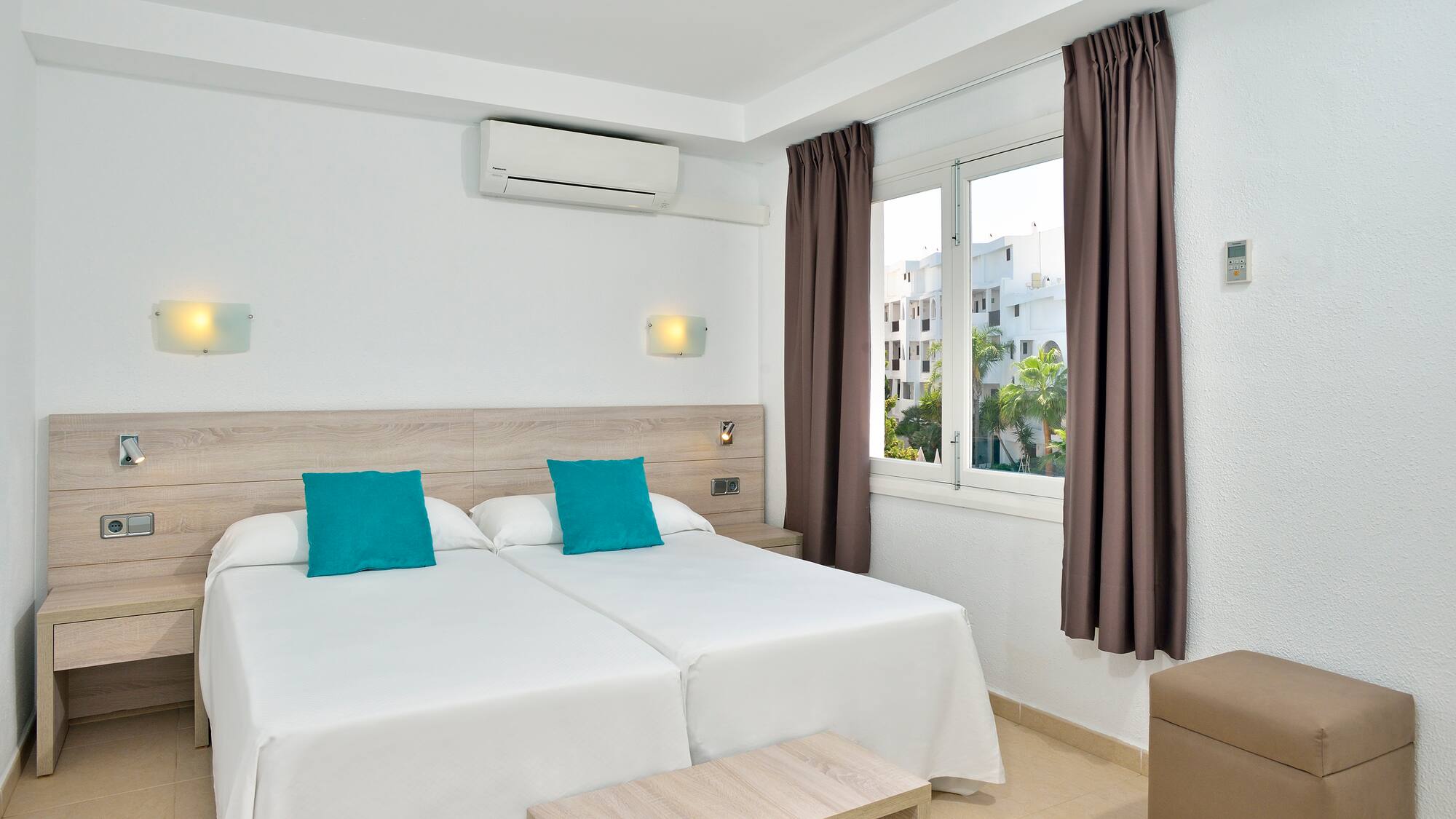 a room with two beds and a window