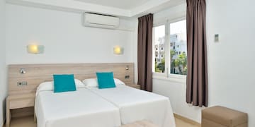 a room with two beds and a window