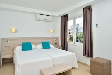 a room with two beds and a window