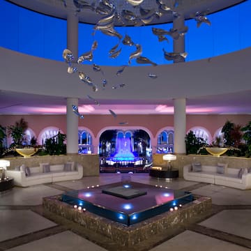 a room with a large pool and a large fountain